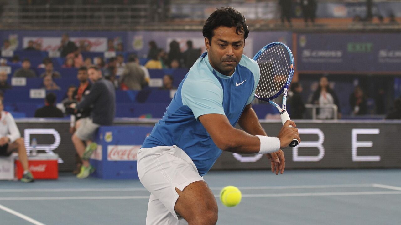 NEW DELHI, INDIA - DECEMBER 12: Leander Paes of Legendary Japanese Warriors in action against Dustin Brown and Karolina Pliskova of OUE Singapore Slammers mixed doubles during the Coca Cola International Premier Tennis League at IG Stadium on December 12, 2015 in New Delhi, India.