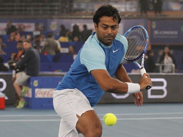NEW DELHI, INDIA - DECEMBER 12: Leander Paes of Legendary Japanese Warriors in action against Dustin Brown and Karolina Pliskova of OUE Singapore Slammers mixed doubles during the Coca Cola International Premier Tennis League at IG Stadium on December 12, 2015 in New Delhi, India.