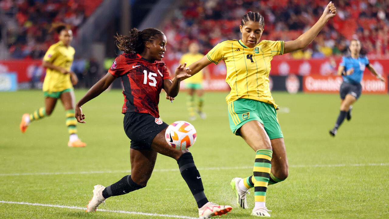 TORONTO, CANADA - SEPTEMBER 26: Nichelle Prince #15 of Canada battles for the ball with Chantelle Swanby #4 of Jamaica during a Paris 2024 Olympic Games Qualifier match at BMO Field on September 26, 2023 in Toronto, Canada.