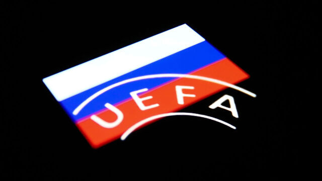 UEFA logo displayed on a phone screen and Russian flag displayed on a phone screen are seen in this multiple exposure illustration photo taken in Krakow, Poland on February 28, 2022. (Photo illustration by Jakub Porzycki/NurPhoto via Getty Images)