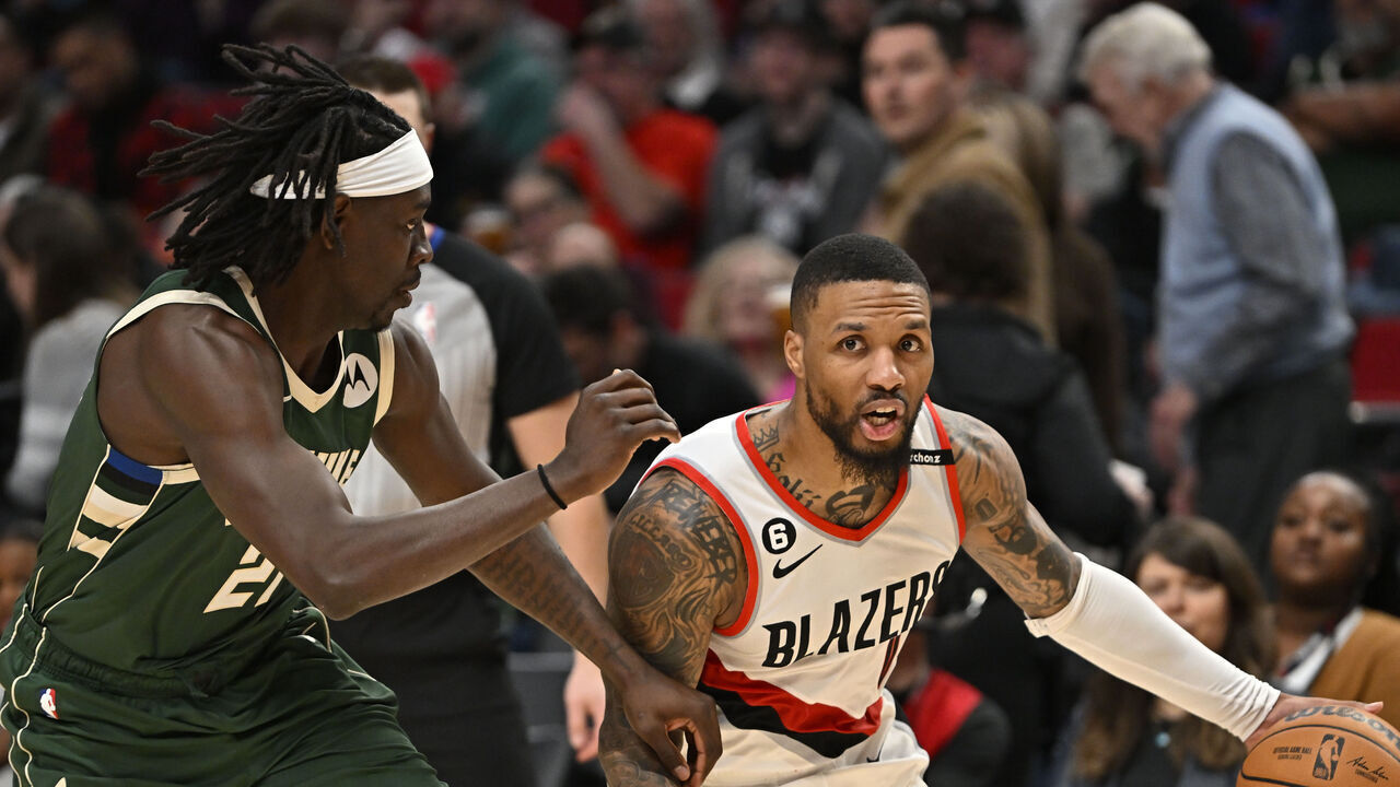 PORTLAND, OREGON - FEBRUARY 06: Damian Lillard #0 of the Portland Trail Blazers dribbles against Jrue Holiday #21 of the Milwaukee Bucks during the third quarter at the Moda Center on February 06, 2023 in Portland, Oregon. The Milwaukee Bucks won 127-108.