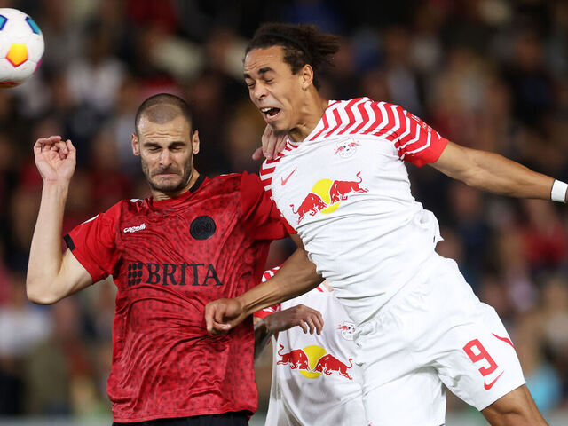 Leipzig's Benjamin Sesko, top, heads the ball during the German