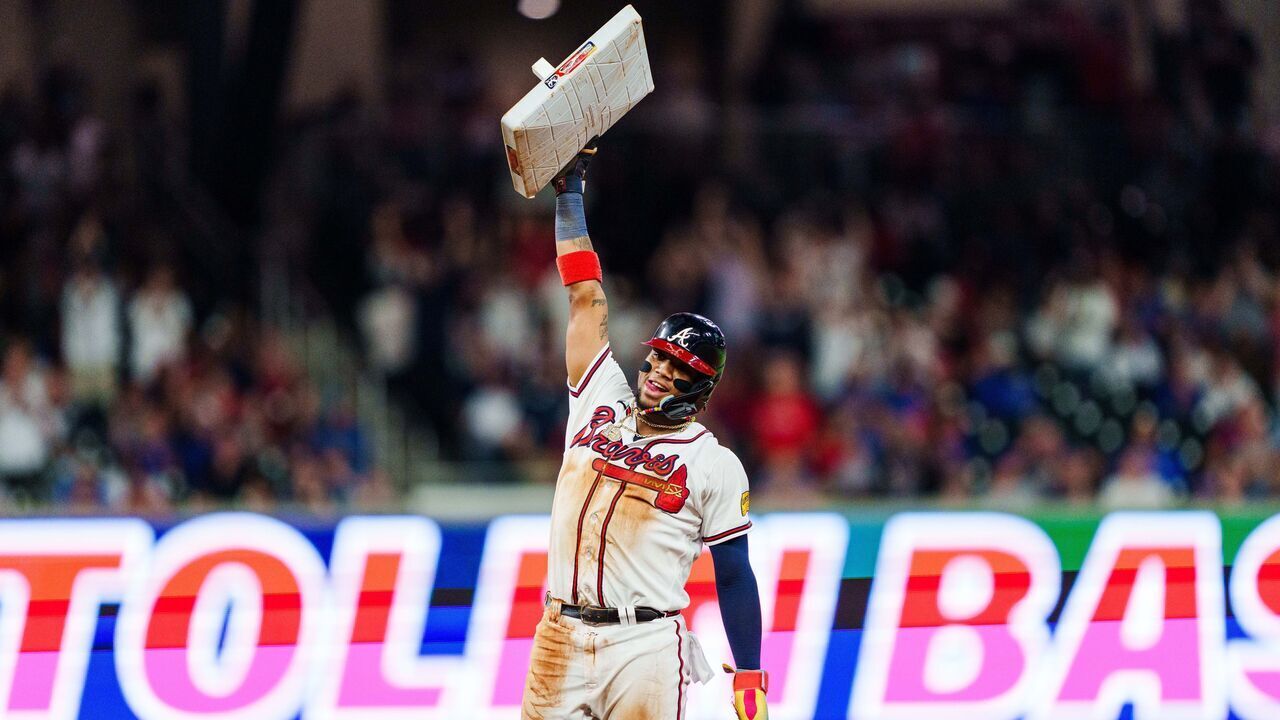 ATLANTA, GA - SEPTEMBER 27: Ronald Acuña Jr. #13 of the Atlanta Braves celebrates after stealing second base in the tenth inning against the Chicago Cubs at Truist Park on September 27, 2023 in Atlanta, Georgia. Acuña Jr. is the first player in MLB history to hit 40 home runs and steal 70 bases in a single season.