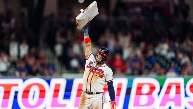 ATLANTA, GA - SEPTEMBER 27: Ronald Acuña Jr. #13 of the Atlanta Braves celebrates after stealing second base in the tenth inning against the Chicago Cubs at Truist Park on September 27, 2023 in Atlanta, Georgia. Acuña Jr. is the first player in MLB history to hit 40 home runs and steal 70 bases in a single season.