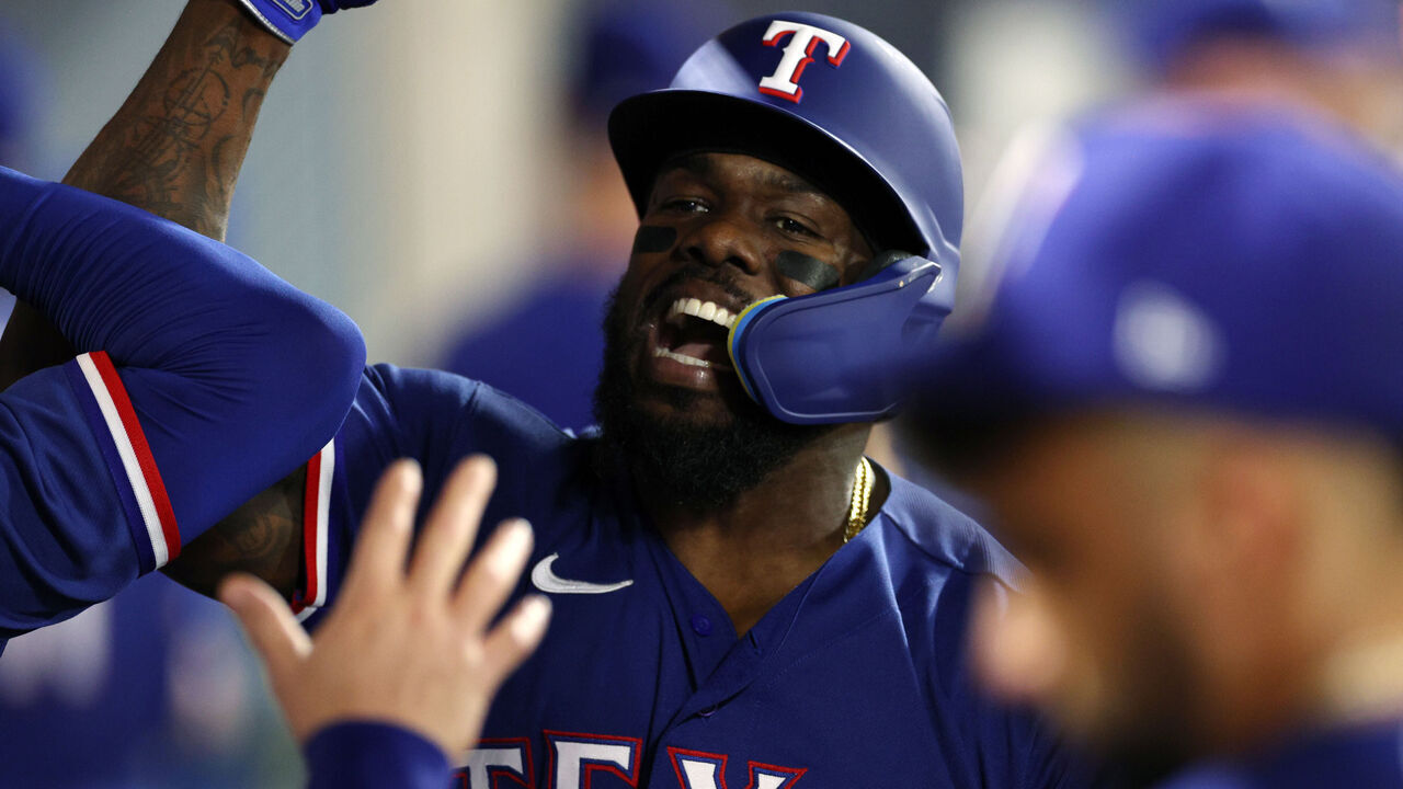 ANAHEIM, CALIFORNIA - SEPTEMBER 27: Adolis Garcia #53 of the Texas Rangers celebrates in the dugout after hitting a one-run home run during the third inning against pitcher Griffin Canning #47 of the Los Angeles Angels at Angel Stadium of Anaheim on September 27, 2023 in Anaheim, California.