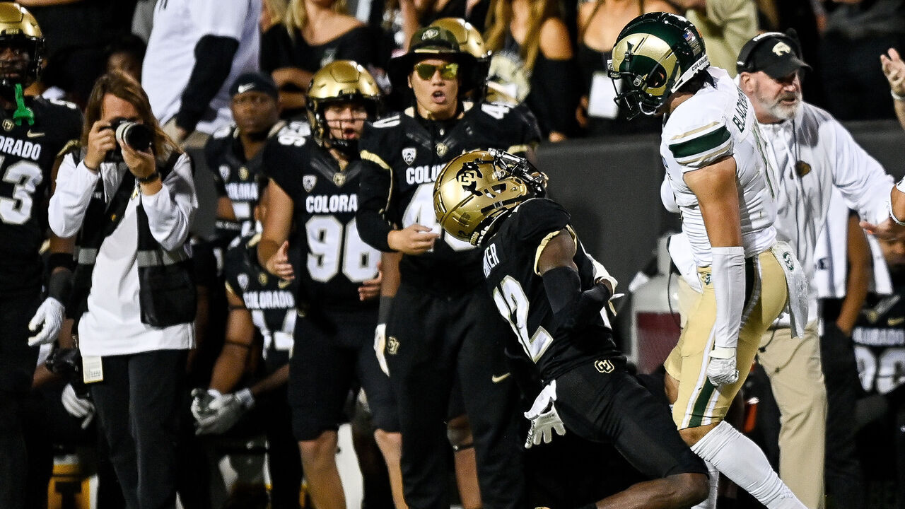 BOULDER, CO - SEPTEMBER 16: Wide receiver Travis Hunter #12 of the Colorado Buffaloes is hit near the sideline on a pass attempt by defensive back Henry Blackburn #11 of the Colorado State Rams at Folsom Field on September 16, 2023 in Boulder, Colorado.