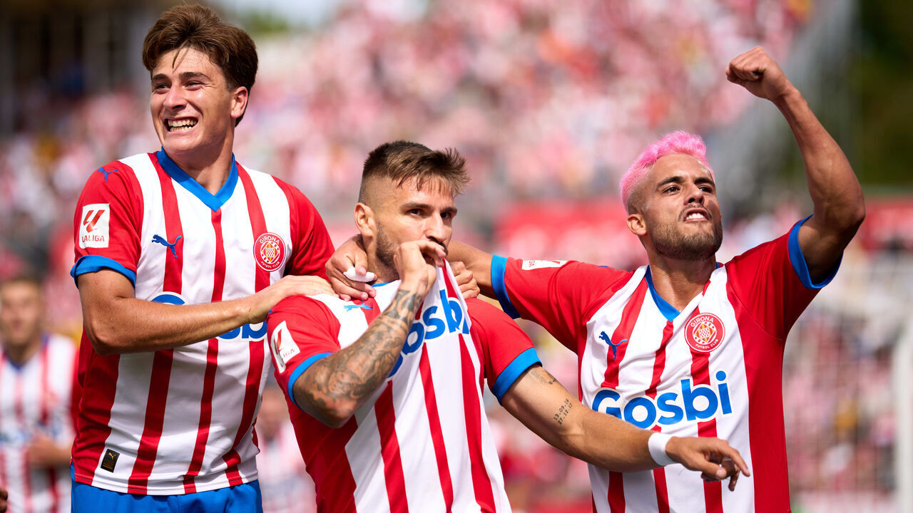 GIRONA, SPAIN - SEPTEMBER 03: Cristian Portugues 'Portu' of Girona FC celebrates with his teammates Pablo Torre and Yan Couto after scoring his team's first goal during the LaLiga EA Sports match between Girona FC and UD Las Palmas at Montilivi Stadium on September 03, 2023 in Girona, Spain.