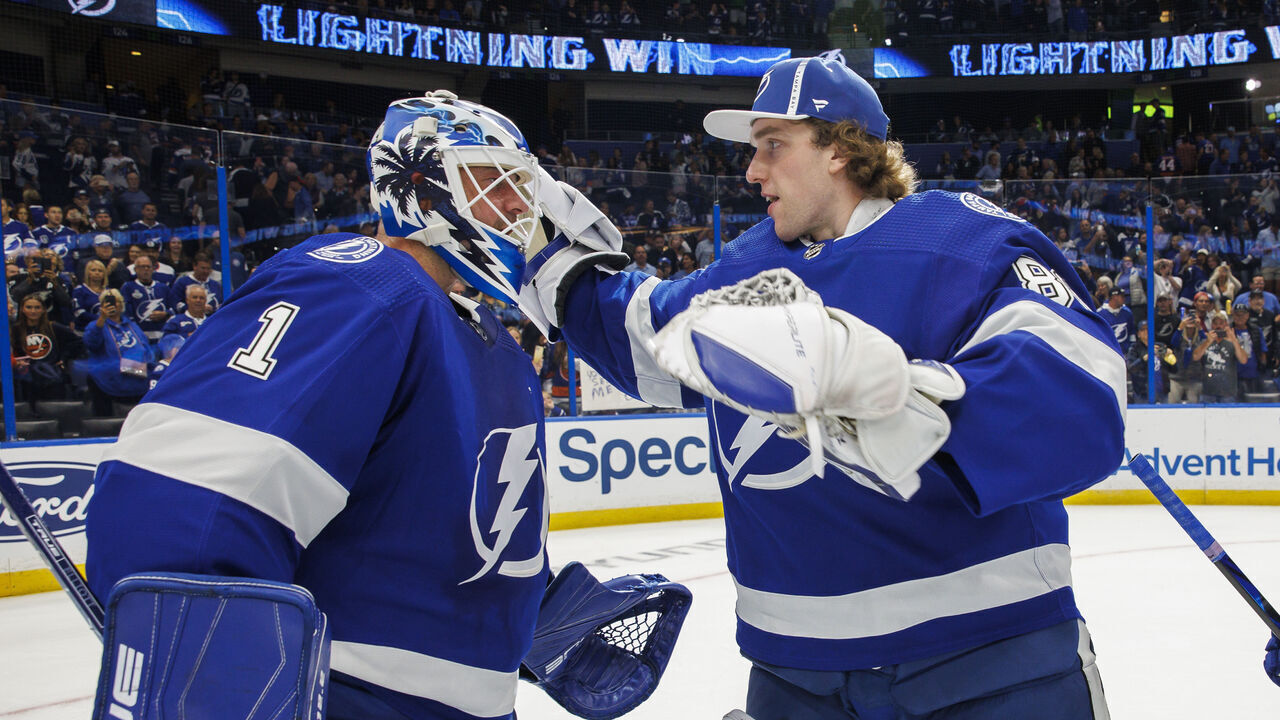TAMPA, FL - OCTOBER 22: Goalies Brian Elliott #1 and Andrei Vasilevskiy #88 of the Tampa Bay Lightning celebrate the win against the New York Islanders at Amalie Arena on October 22, 2022 in Tampa, Florida.