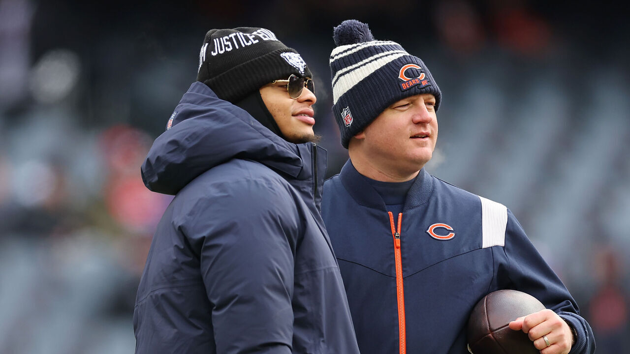 CHICAGO, ILLINOIS - JANUARY 08: Justin Fields #1 of the Chicago Bears talks with offensive coordinator Luke Getsy prior to the game against the Minnesota Vikings at Soldier Field on January 08, 2023 in Chicago, Illinois.