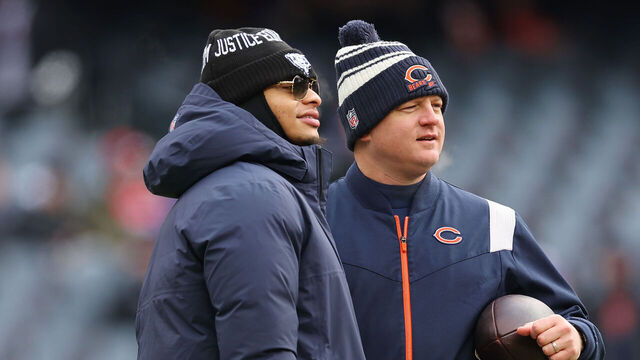 CHICAGO, ILLINOIS - JANUARY 08: Justin Fields #1 of the Chicago Bears talks with offensive coordinator Luke Getsy prior to the game against the Minnesota Vikings at Soldier Field on January 08, 2023 in Chicago, Illinois.