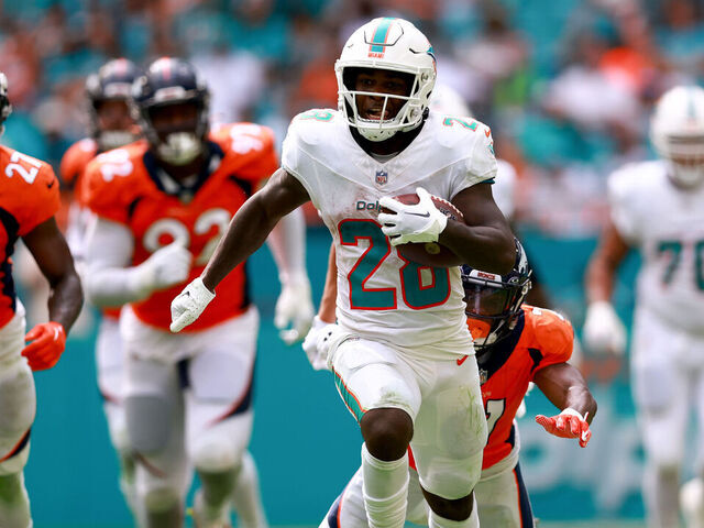 MIAMI GARDENS, FLORIDA - SEPTEMBER 24: De'Von Achane #28 of the Miami Dolphins rushes for a touchdown against the Denver Broncos during the fourth quarter at Hard Rock Stadium on September 24, 2023 in Miami Gardens, Florida.