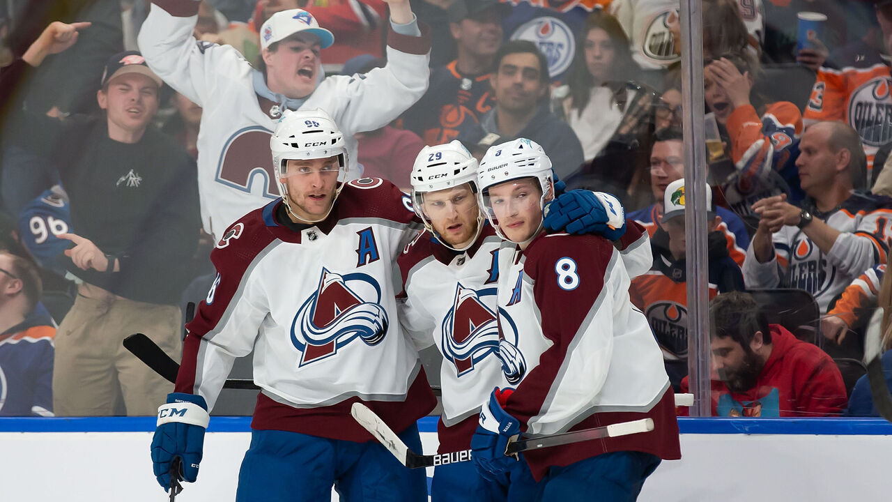 EDMONTON, AB - APRIL 09: Mikko Rantanen #96, Nathan MacKinnon #29 and Cale Makar #8 of the Colorado Avalanche celebrate a goal against the Edmonton Oilers during the third period at Rogers Place on April 9, 2022 in Edmonton, Canada.
