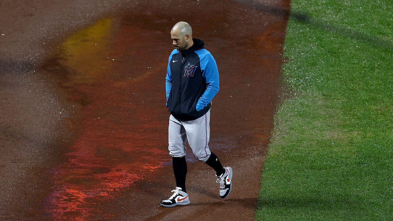 NEW YORK, NEW YORK - SEPTEMBER 28: Manager Skip Schumaker #55 of the Miami Marlins walks to the dugout as the umpire crew chief inspects field conditions after a long rain delay between the New York Mets and the Miami Marlins at Citi Field on September 28, 2023 in the Flushing neighborhood of the Queens borough of New York City.