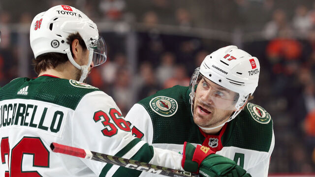 PHILADELPHIA, PENNSYLVANIA - MARCH 23: Mats Zuccarello #36 and Marcus Foligno #17 of the Minnesota Wild chat during a stoppage in play against the Philadelphia Flyers at the Wells Fargo Center on March 23, 2023 in Philadelphia, Pennsylvania.