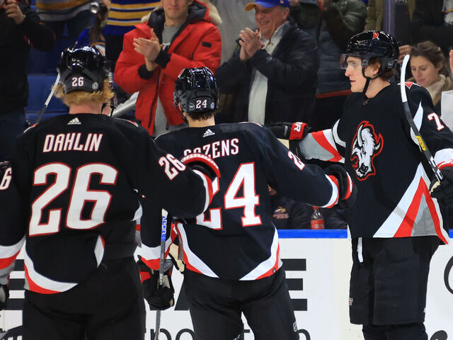 BUFFALO, NY - DECEMBER 13: Tage Thompson #72 celebrates his third period goal with Dylan Cozens #24 and Rasmus Dahlin #26 of the Buffalo Sabres during an NHL game against the Los Angeles Kings on December 13, 2022 at KeyBank Center in Buffalo, New York.