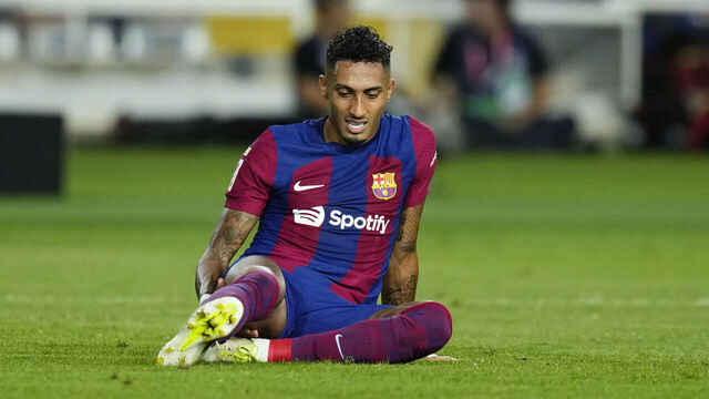 Raphinha right winger of Barcelona and Brazil and Adria Pedrosa left-back of Sevilla and Spain compete for the ball during the LaLiga EA Sports match between FC Barcelona and Sevilla FC at Estadi Olimpic Lluis Companys on September 29, 2023 in Barcelona, Spain.