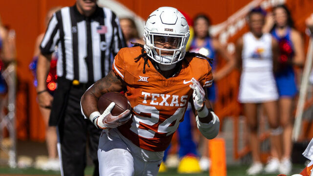 AUSTIN, TX - SEPTEMBER 30: Texas Longhorns running back Jonathon Brooks (24) runs the ball through the offensive line during the Big 12 football game between Texas Longhorns and Kansas Jayhawks on September 30, 2023, at Darrell K Royal-Texas Memorial Stadium in Austin, TX.