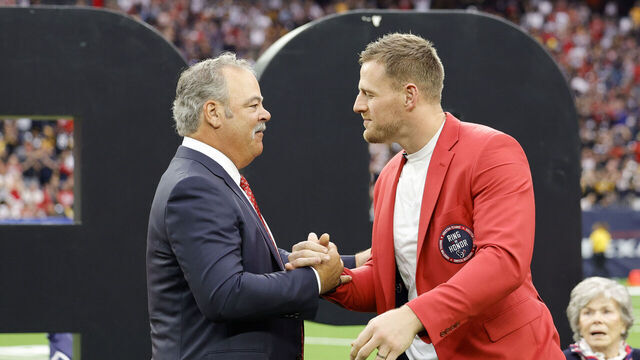 HOUSTON, TEXAS - OCTOBER 01: Houston Texans CEO Cal McNair shakes hands with former player J.J. Watt during a ceremony inducting Watt into the Texans Ring of Honor during a game against the Pittsburgh Steelers at NRG Stadium on October 01, 2023 in Houston, Texas.