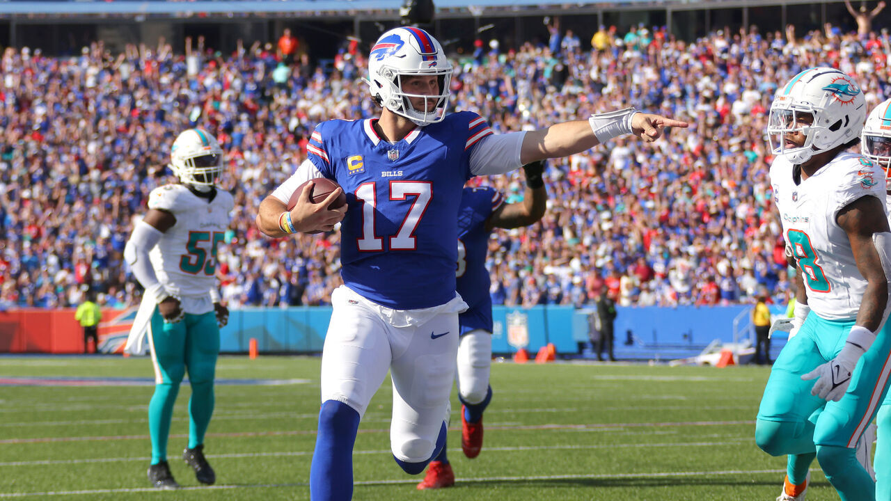 ORCHARD PARK, NEW YORK - OCTOBER 01: Josh Allen #17 of the Buffalo Bills runs the ball for a touchdown against the Miami Dolphins during the fourth quarter at Highmark Stadium on October 01, 2023 in Orchard Park, New York.
