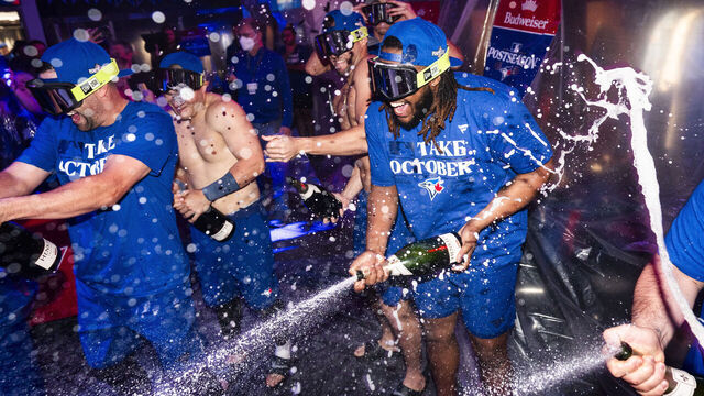 TORONTO, ON - OCTOBER 1: Vladimir Guerrero Jr. #27 of the Toronto Blue Jays sprays champagne in the locker room to celebrate their playoff berth, after the final MLB game of the season against the Tampa Bay Rays at the Rogers Centre on October 1, 2023 in Toronto, Ontario, Canada.