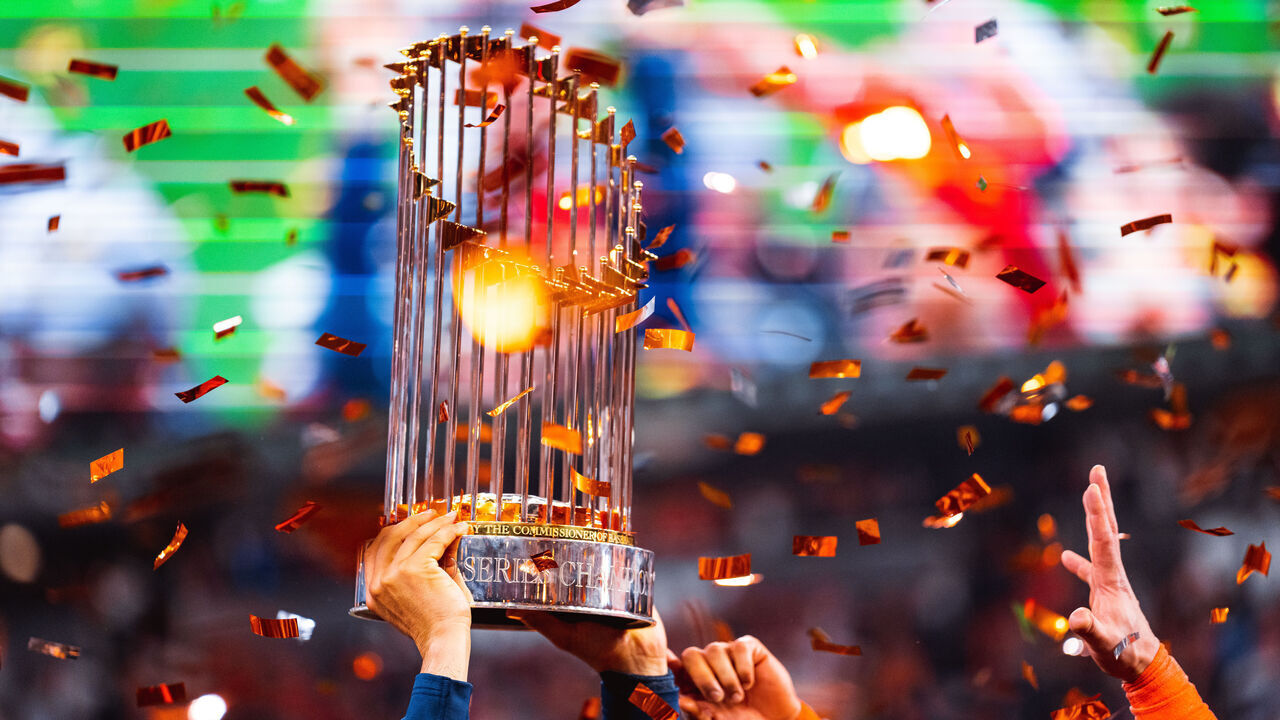 HOUSTON, TX - NOVEMBER 5: Members of the Houston Astros hoist up the Commissioners Trophy after the Astros defeated the Philadelphia Phillies in Game 6 of the 2022 World Series on November 5, 2022 at Minute Maid Park in Houston, Texas.