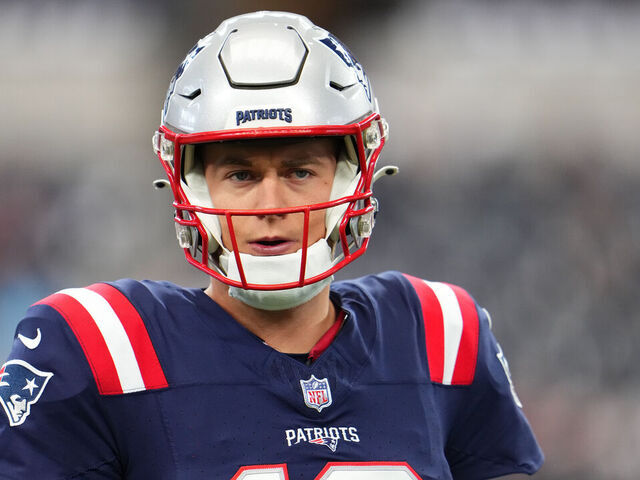 New England Patriots quarterback Mac Jones (10) warms up before