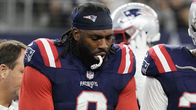 ARLINGTON, TEXAS - OCTOBER 01: Matthew Judon #9 of the New England Patriots holds his arm while walking off the field while consoled by Anfernee Jennings #33 of the New England Patriots during the third quarter against the Dallas Cowboys at AT&T Stadium on October 01, 2023 in Arlington, Texas.