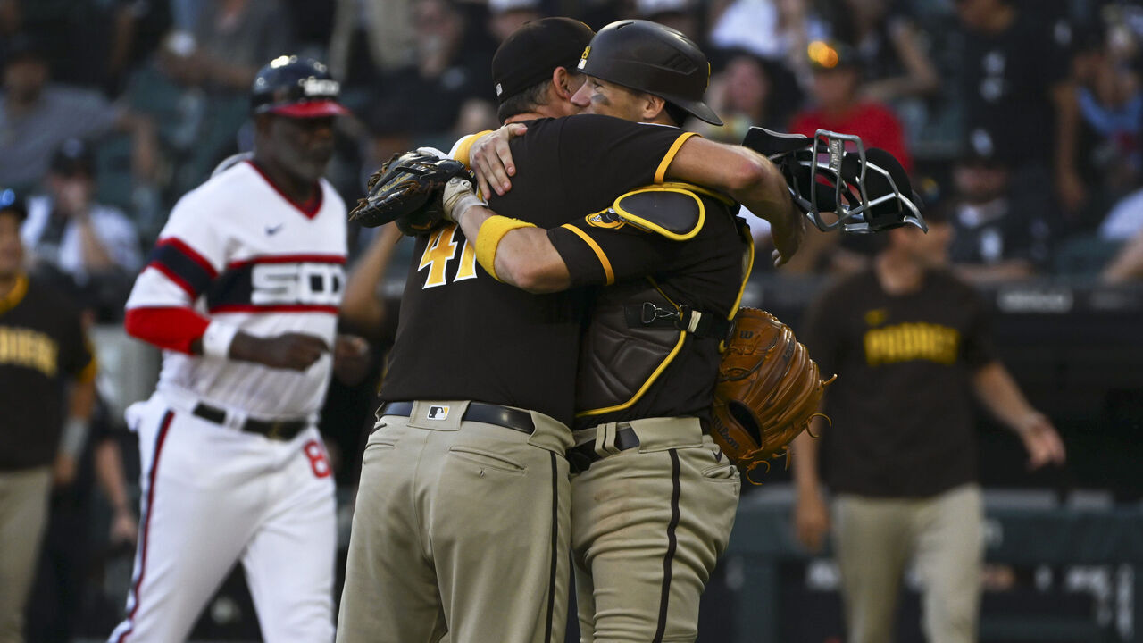 CHICAGO, ILLINOIS - OCTOBER 01: Rich Hill #41 of the San Diego Padres hugs Brett Sullivan #29 of the San Diego Padres after a win over the Chicago White Sox at Guaranteed Rate Field on October 01, 2023 in Chicago, Illinois. The Padres defeated the White Sox 2-1.