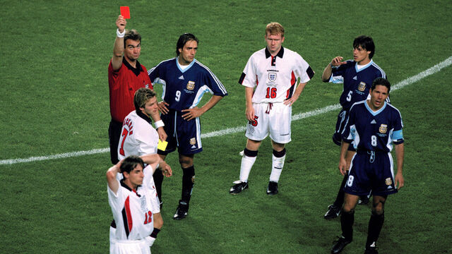 30 June 1998 Fifa World Cup - England v Argentina - Referee Kim Milton Nielsen shows the red card to David Beckham as Paul Scholes (16) looks accusingly at Argentinean captain Diego Simeone (8) who was involved in the incident - Gary Neville (12) Gabriel Batistuta (9) and Matias Almeyda (5).