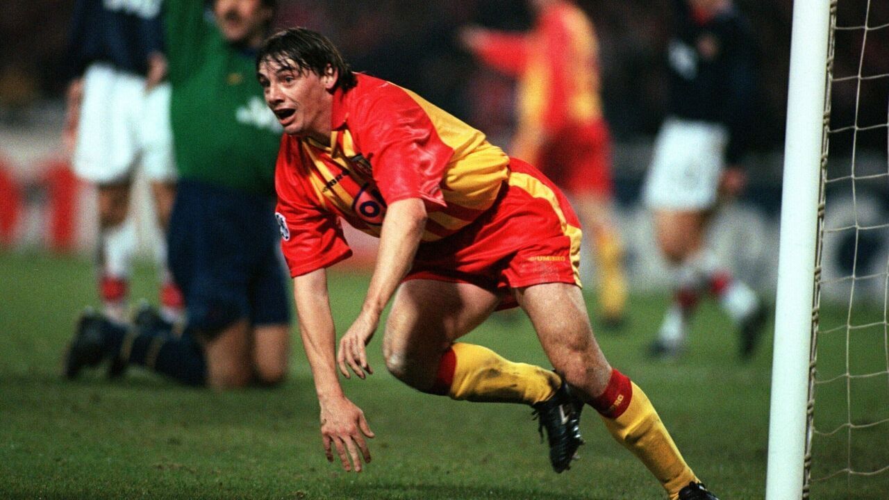 RC Lens's Michael Debeve celebrates scoring the winning goal, as Arsenal goalkeeper David Seaman appeals for offside in the background