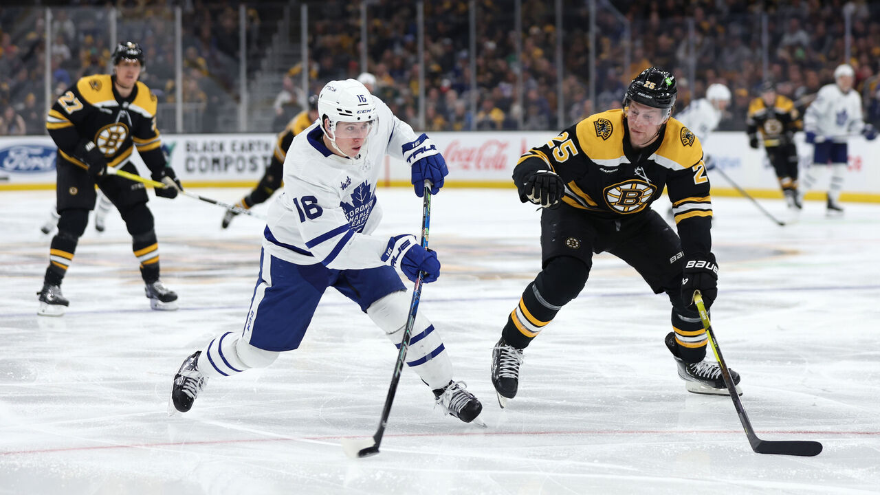 BOSTON, MASSACHUSETTS - APRIL 06: Mitchell Marner #16 of the Toronto Maple Leafs takes a shot past Brandon Carlo #25 of the Boston Bruins during the second period at TD Garden on April 06, 2023 in Boston, Massachusetts.