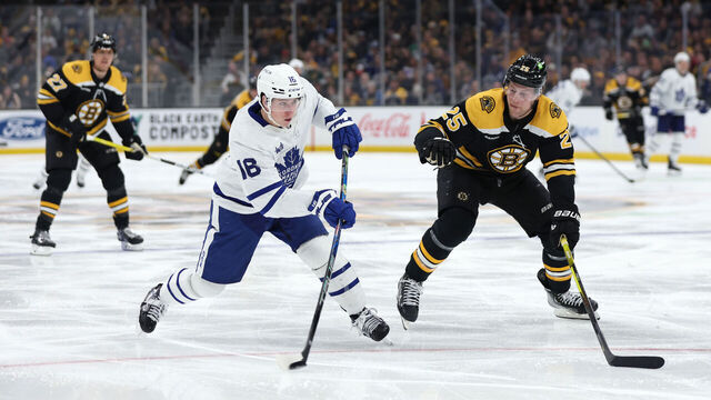 BOSTON, MASSACHUSETTS - APRIL 06: Mitchell Marner #16 of the Toronto Maple Leafs takes a shot past Brandon Carlo #25 of the Boston Bruins during the second period at TD Garden on April 06, 2023 in Boston, Massachusetts.