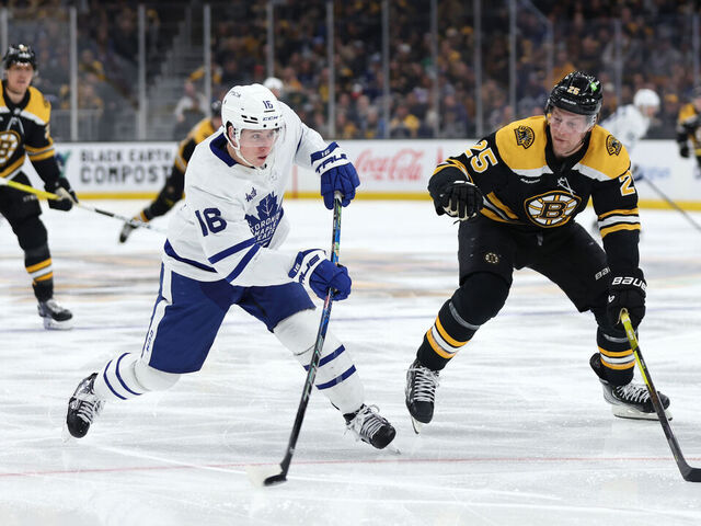 BOSTON, MASSACHUSETTS - APRIL 06: Mitchell Marner #16 of the Toronto Maple Leafs takes a shot past Brandon Carlo #25 of the Boston Bruins during the second period at TD Garden on April 06, 2023 in Boston, Massachusetts.
