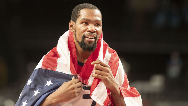 TOKYO, JAPAN August 7: Kevin Durant #7 of the United States celebrates the teams gold medal victory with the United States flag after the France V USA basket final for men at the Saitama Super Arena during the Tokyo 2020 Summer Olympic Games on August 7, 2021 in Tokyo, Japan.