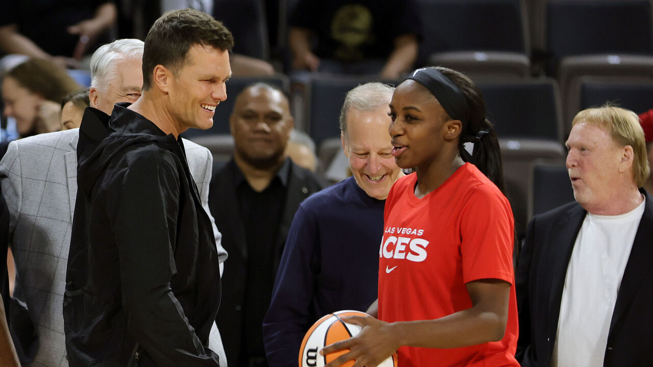 LAS VEGAS, NEVADA - MAY 31: Tampa Bay Buccaneers quarterback Tom Brady (L) talks with Jackie Young #0 of the Las Vegas Aces during halftime of the Aces' game against the Connecticut Sun at Michelob ULTRA Arena on May 31, 2022 in Las Vegas, Nevada. The Aces defeated the Sun 89-81.
