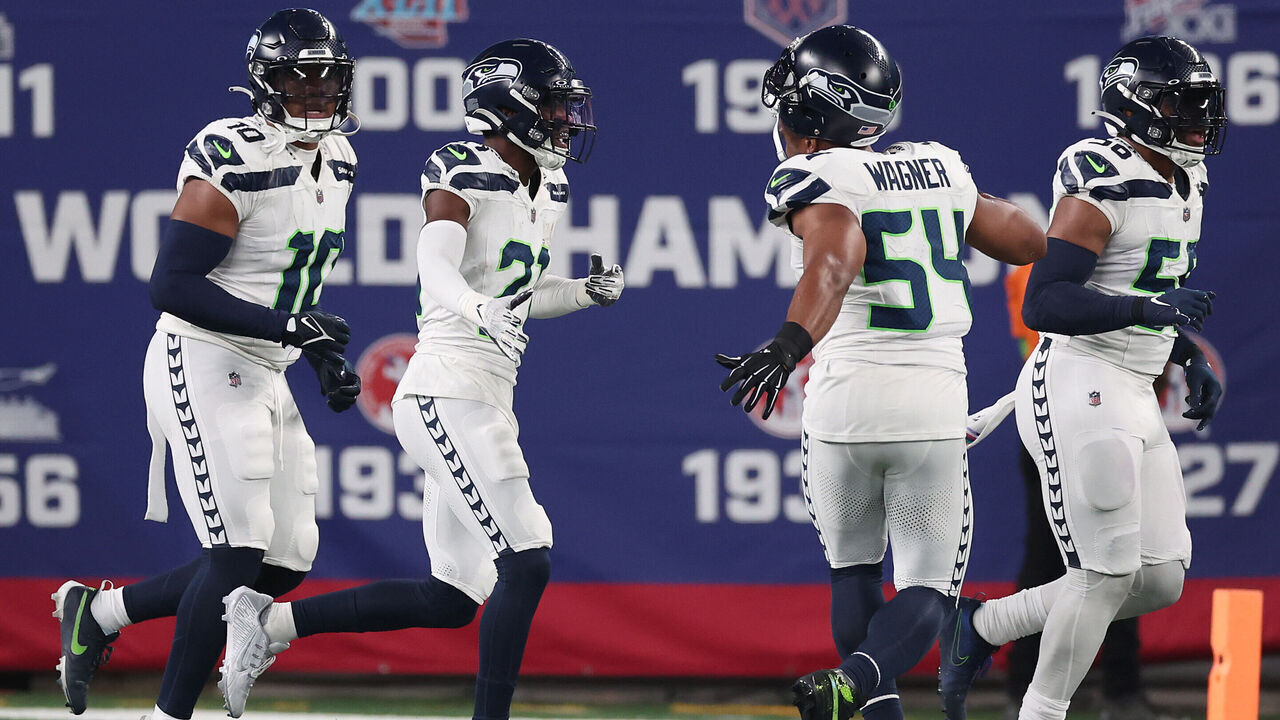 EAST RUTHERFORD, NEW JERSEY - OCTOBER 02: Devon Witherspoon #21 of the Seattle Seahawks celebrates his interception return for a touchdown with teammates during the third quarter against the New York Giants at MetLife Stadium on October 02, 2023 in East Rutherford, New Jersey.