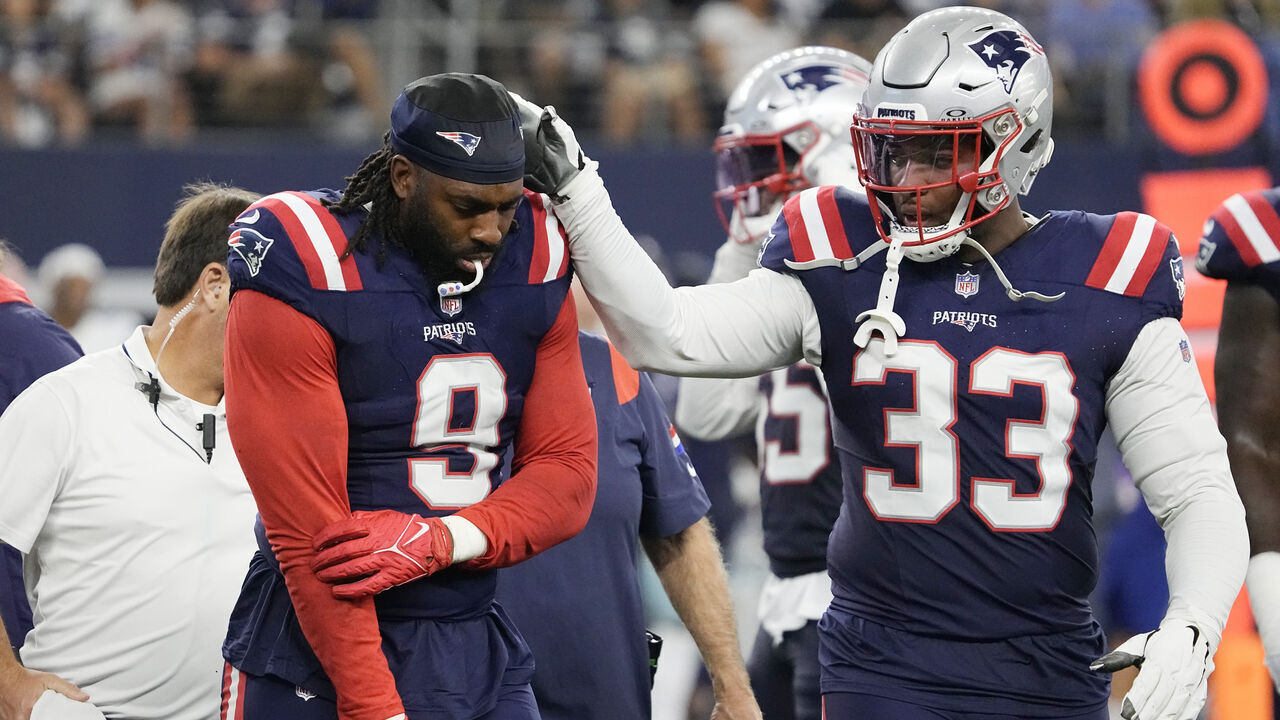 ARLINGTON, TEXAS - OCTOBER 01: Matthew Judon #9 of the New England Patriots holds his arm while walking off the field while consoled by Anfernee Jennings #33 of the New England Patriots during the third quarter against the Dallas Cowboys at AT&T Stadium on October 01, 2023 in Arlington, Texas.
