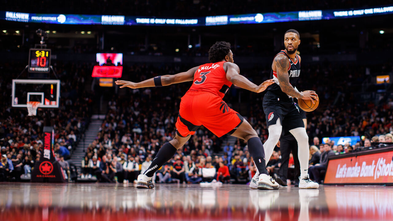 TORONTO, ON - JANUARY 08: Damian Lillard #0 of the Portland Trail Blazers dribbles up the ball against O.G. Anunoby #3 of the Toronto Raptors during the second half of their NBA game at Scotiabank Arena on January 8, 2023 in Toronto, Canada.