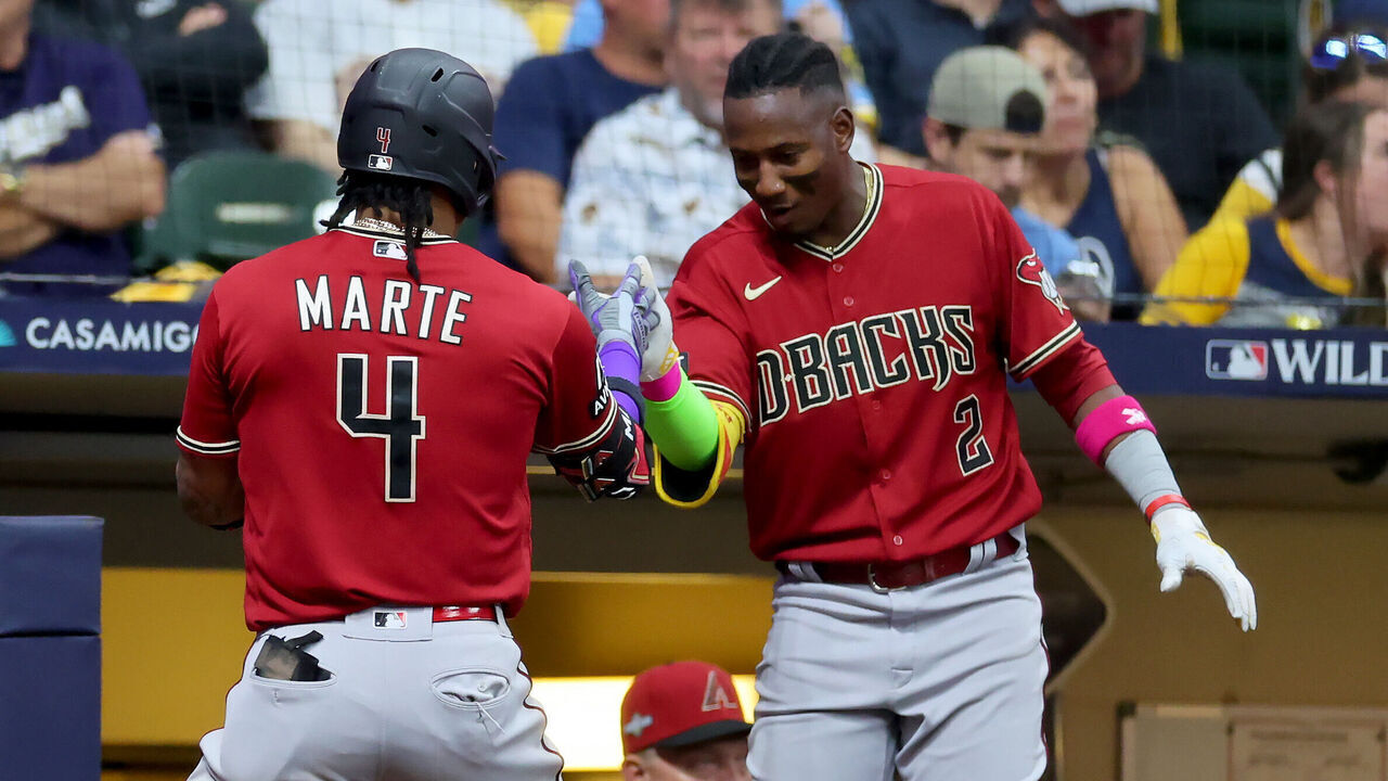 MILWAUKEE, WISCONSIN - OCTOBER 03: Ketel Marte #4 and Geraldo Perdomo #2 of the Arizona Diamondbacks celebrate after Marte hit a home run in the third inning against the Milwaukee Brewers during Game One of the Wild Card Series at American Family Field on October 03, 2023 in Milwaukee, Wisconsin.