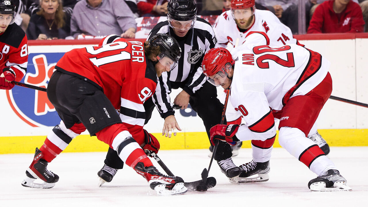 NEWARK, NJ - MAY 07: New Jersey Devils center Dawson Mercer (91) takes a face-off against Carolina Hurricanes center Sebastian Aho (20) during Game 3 of an Eastern Conference Second Round playoff game between the Carolina Hurricanes and the New Jersey Devils on May 7, 2023, at Prudential Center in Newark, New Jersey.