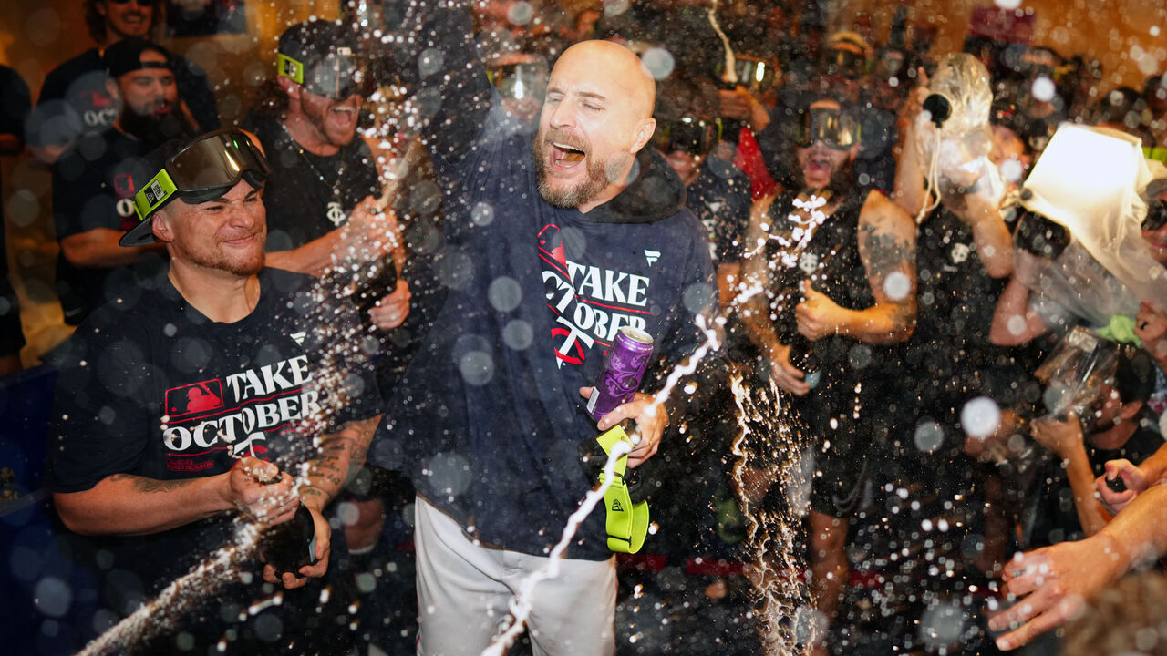MINNEAPOLIS, MN - OCTOBER 04: Manager Rocco Baldelli #5 of the Minnesota Twins celebrates with players in the clubhouse after the Twins defeated the Toronto Blue Jays in Game 2 of the Wild Card Series at Target Field on Wednesday, October 4, 2023 in Minneapolis, Minnesota.