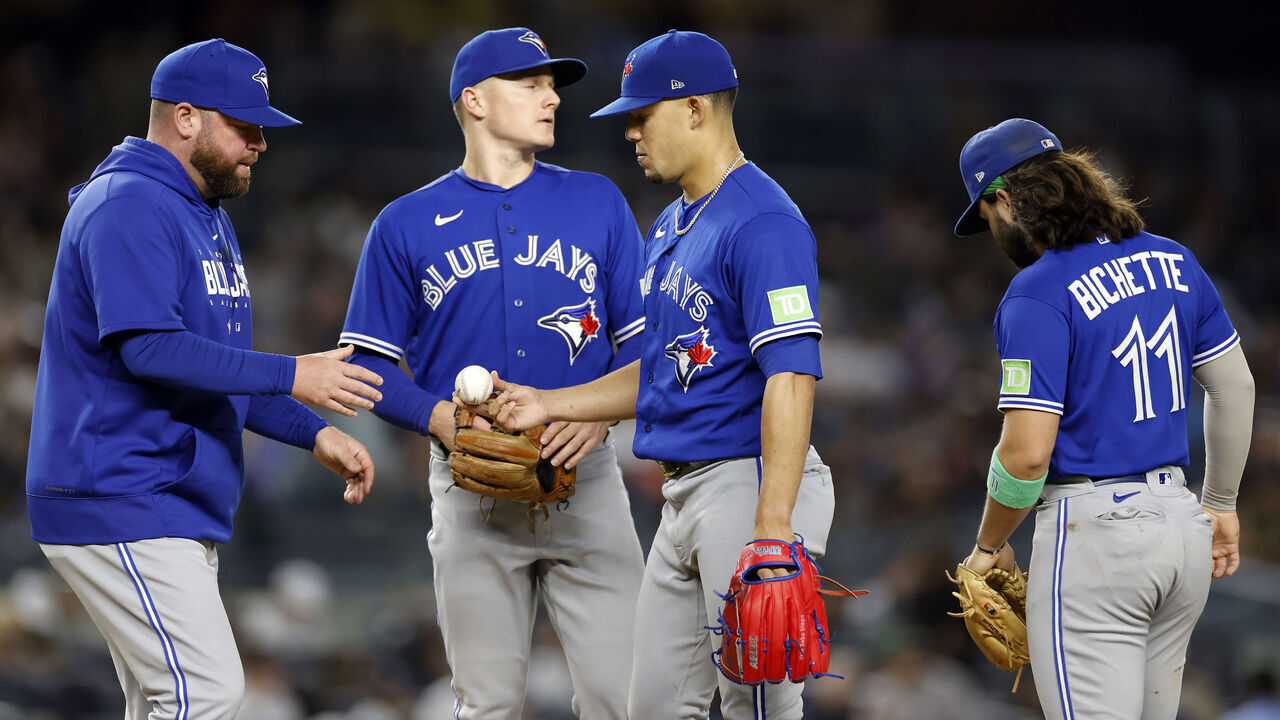 NEW YORK, NEW YORK - SEPTEMBER 21: Manager John Schneider #14 of the Toronto Blue Jays takes Jose Berrios #17 out of the game during the sixth inning of the game against the New York Yankees at Yankee Stadium on September 21, 2023 in the Bronx borough of New York City.