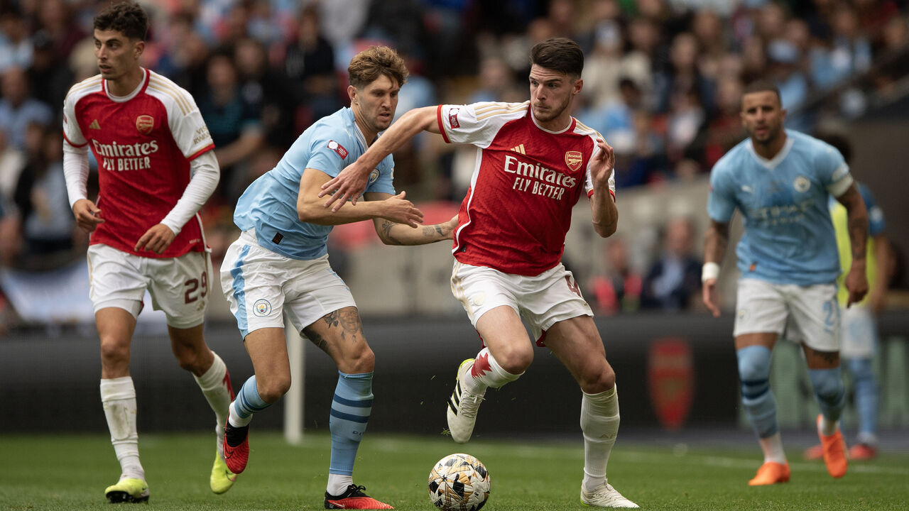 LONDON, ENGLAND - AUGUST 06: John Stones of Manchester City battles with Declan Rice of Arsenal during The FA Community Shield match between Manchester City against Arsenal at Wembley Stadium on August 06, 2023 in London, England.