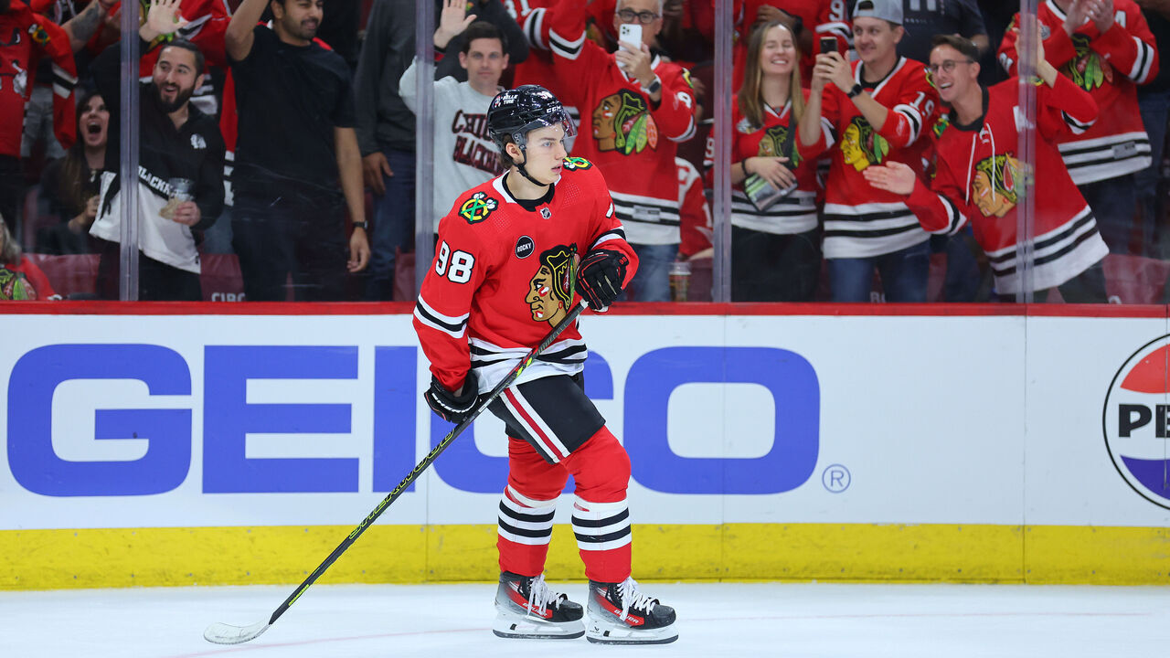 CHICAGO, ILLINOIS - OCTOBER 03: Connor Bedard #98 of the Chicago Blackhawks celebrates after scoring a empty-net goal against the Detroit Red Wings during the third period of preseason game at the United Center on October 03, 2023 in Chicago, Illinois.