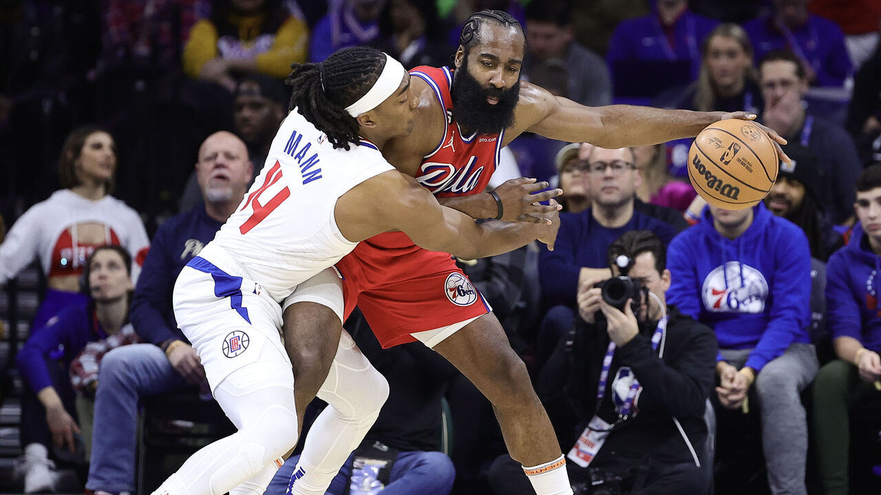 PHILADELPHIA, PENNSYLVANIA - DECEMBER 23: Terance Mann #14 of the LA Clippers guards James Harden #1 of the Philadelphia 76ers during the second quarter at Wells Fargo Center on December 23, 2022 in Philadelphia, Pennsylvania.