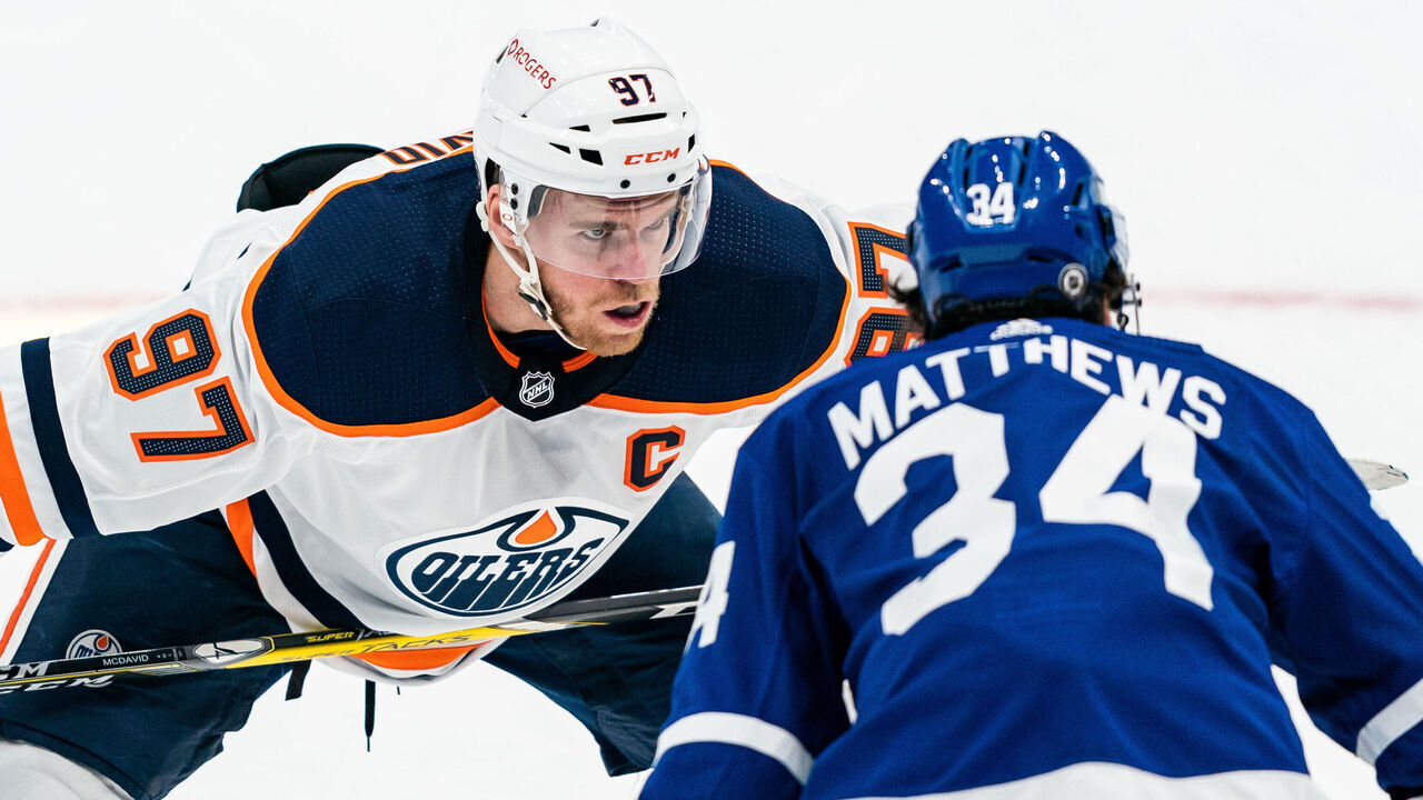TORONTO, ON - MARCH 29: Connor McDavid #97 of the Edmonton Oilers takes a face off against Auston Matthews #34 of the Toronto Maple Leafs during the first period at the Scotiabank Arena on March 29, 2021 in Toronto, Ontario, Canada.
