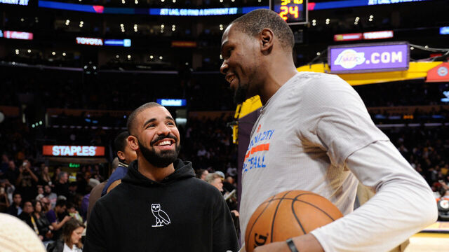 LOS ANGELES, CA - DECEMBER 23: Drake talks to Kevin Durant at a basketball game between the Oklahoma City Thunder and the Los Angeles Lakers at Staples Center on December 23, 2015 in Los Angeles, California.