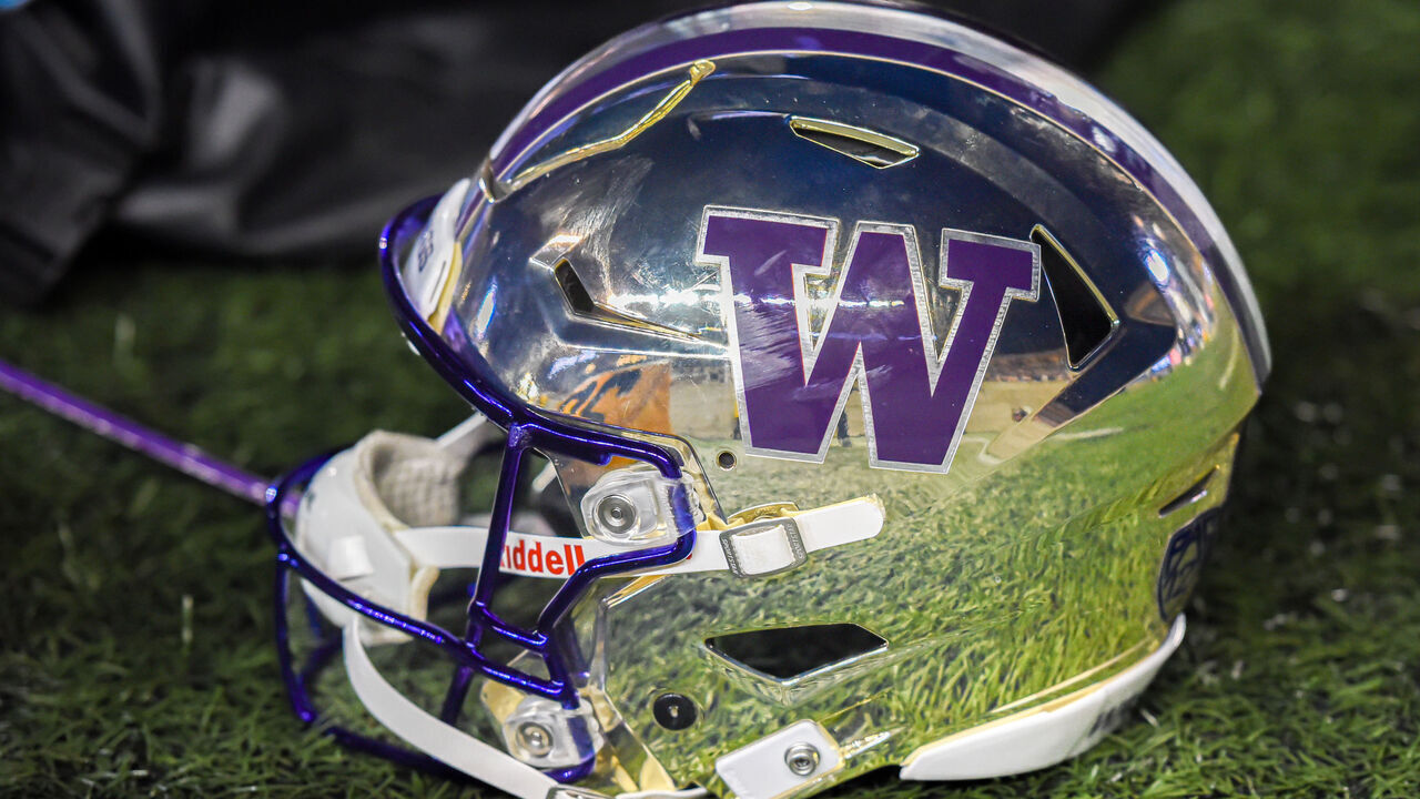 BERKELEY, CA - OCTOBER 22: The sidelines reflected off of the chrome and purple helmet sported by the Washington Huskies at the game between the Washington Huskies and the Cal Bears on Saturday, October 22, 2022 at Memorial Stadium in Berkeley, California.
