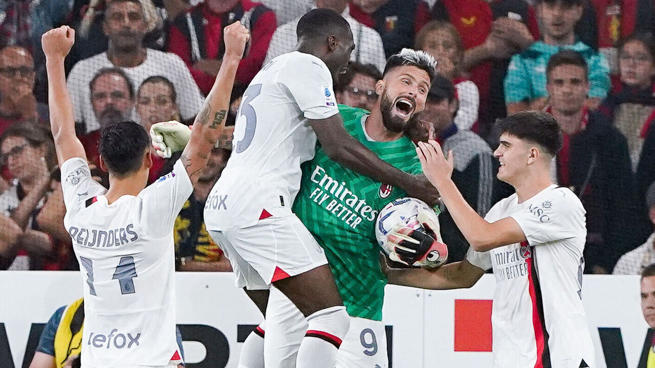 Olivier Giroud of AC Milan celebrates the victory with his teammates playing as goalkeeper after Mike Maignan of AC Milan received a red card during the Serie A Tim match between Genoa CFC and AC Milan at Luigi Ferrari Stadium on October 7, 2023 in Genoa, Italy.