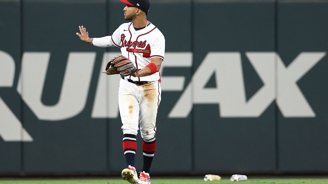 ATLANTA, GEORGIA - OCTOBER 07: Eddie Rosario #8 of the Atlanta Braves reacts as fans throw objects onto the field during the eighth inning between the Atlanta Braves and the Philadelphia Phillies during Game One of the Division Series at Truist Park on October 07, 2023 in Atlanta, Georgia.